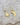 Gold hammered brass star and moon earrings on a stone surface.