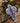 Large lilac wavey lines recycled paper decoration hanging at an eco-friendly party.