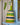 Woven rattle shaker with green, blue, and beige stripes on a light blue surface.