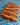 Wooden cutting board with a checkered pattern on a blue and white tiled surface