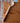 Wooden ladle on a wooden surface with a brick wall background