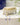 Bar of soap on an AARVEN handmade white soapstone soap dish on a tiled surface.