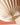 A close-up of a cream-coloured paper light shade hanging decoration by AARVEN, shown in a radial fan shape against a softly blurred warm terracotta background.