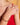 Close-up of a person's hand wearing gold rings and a bracelet on a blurred background