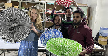 AARVEN founder and designer Amy Fleuriot-Reade with artisans in Jaipur holding the brands best selling paper light shades