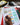 Hand holding a pen over patterned paper with stationery items in the background