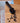 Black coffee scoop with coffee beans on a wooden surface