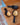 Three wooden spoons with black handles on a wooden surface.