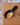 Wooden scoop with black handle on a wooden surface
