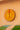 Decorative African sun mask in yellow and orange with geometric design on a peach wall