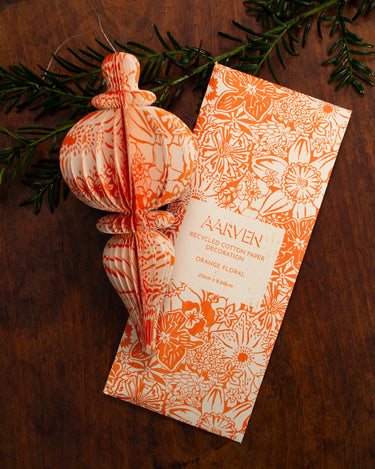 Decorative floral orange and white hanging paper decoration with storage envelope.