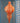 Decorative orange and white hanging ornament on a blue wall with white patterns.