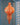 Decorative orange and white hanging ornament on a blue wall with white patterns.