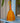 Woven rattle with orange and yellow pattern on a blue shelf