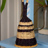 Decorative woven rattle on a blue surface with a neutral background in a nursery