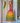 Rainbow woven rattle toy with a handle on a shelf