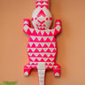 Decorative hand carved Ghanaian wall art with fluoro pink and white geometric patterns on a peach background