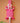 Decorative hand carved Ghanaian wall art with fluoro pink and white geometric patterns on a peach background