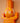 Close up of AARVEN orange geometric crocodile wall art, hand carved by artisans in Ghana, on a peach background