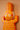Close up of AARVEN orange geometric crocodile wall art, hand carved by artisans in Ghana, on a peach background