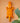 Orange geometric crocodile wall art, hand carved in Ghana, with a plant in the foreground on a peach background