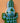 Decorative hand carved crocodile wall art with a blue and green geometric design on a peach background