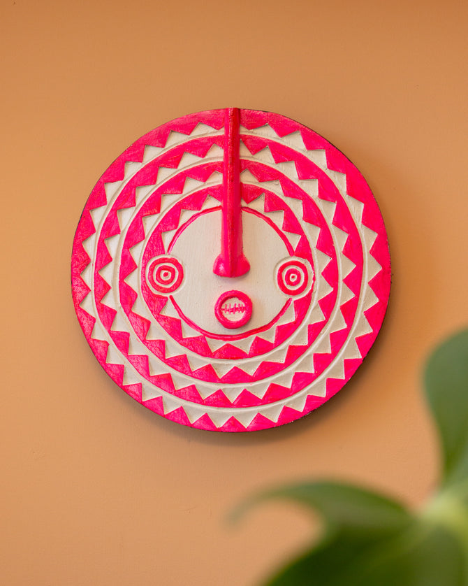 Fluoro Pink and White mini African sun mask wall decor on peach background