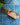 Wooden scoop filled with oats on a blue and white patterned tile background
