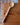 Wooden ladle on a wooden surface with a brick wall background