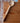 Wooden ladle on a wooden surface with a brick wall background
