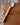 Wooden ladle on a wooden surface with a brick wall background