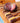 Two figs on a multicolored wooden cutting board