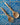 Wooden spoon and fork set on a blue and white wavy tile pattern