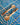 Two wooden spoons on a blue and white wavy tile pattern