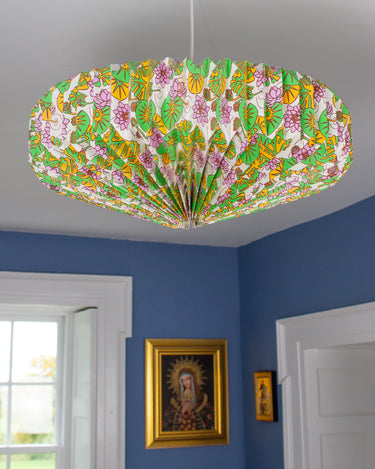 Origami style hanging lightshade illuminating cosy interior