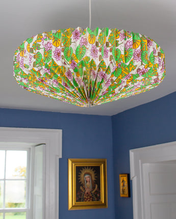 Origami style hanging lightshade illuminating cosy interior