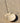 Shell incense holder by AARVEN with an incense stick on a sandy surface