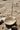 Shell incense burner with a stick on a sandy surface, handmade by artisans in Kenya from soapstone for AARVEN.