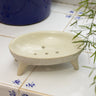 AARVEN handmade white soapstone soap dish on a tiled surface.