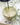 Handmade white soapstone incense holder with an AARVEN incense stick on a tiled surface, with a plant in the background.
