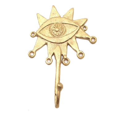 Brass wall hook featuring a bold eye motif for coats or keys