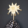 Handcrafted Ghanaian Ashanti brass hook with abstract eye design