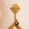 Unique Ashanti brass wall hook showcasing a cultural face mask design