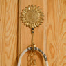 Handcrafted Ghanaian Ashanti brass hook in a sunflower shape