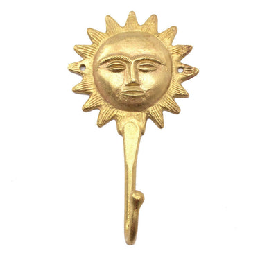 Brass wall hook featuring a radiant sun motif for coats or keys