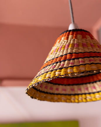 Close up of AARVEN Ghanaian Hand Woven Lightshade, cooli light shade in orange, pink, yellow and natural rattan, handwoven by artisans