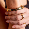 AARVEN Kilifi smooth brass ring with a polished handcrafted finish and matching hammered bangle bracelet.