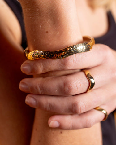 AARVEN Kilifi smooth brass ring with a polished handcrafted finish and matching hammered bangle bracelet.