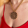 Statement piece necklace by AARVEN with radiant brass Sun Mask centerpiece.

