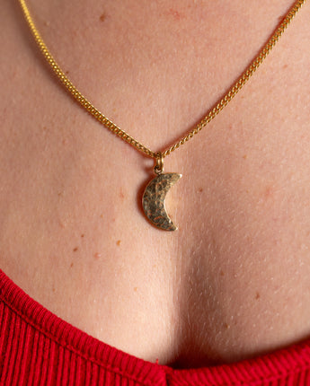 Elegant AARVEN Hammered moon necklace with shimmering hammered finish.